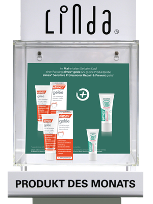 Werbeaufsteller mit dem Logo 'Linda' oben und dem Schriftzug 'PRODUKT DES MONATS' am Sockel. Im Display ist ein Plakat, das für Elmex Gelee wirbt
